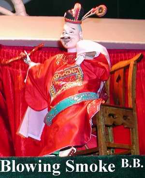 A Zhangzhou hand puppet smoking a pipe. These amazing little people perform acrobatic feats, like spinning plates, juggling--or even tossing each other into the air. Incredible.